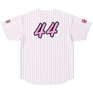 A white short-sleeve sports jersey with thin pink vertical pinstripes, featuring the number '44' in pink with a black outline on the back. Small Union Jack flag patches are visible on both sleeves.