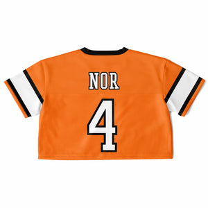 An orange short-sleeve sports jersey shown from the back, featuring the name 'NOR' and number '4' in white with black outlines, and white sleeve stripes with black and orange borders, on a plain white background.