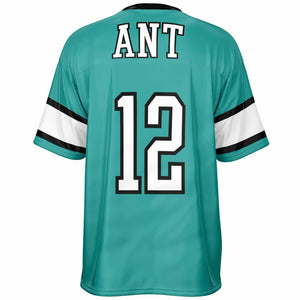 Back view of a teal sports jersey with 'ANT' and the number '12' in white with black outlines, featuring white and black striped sleeves, on a white background.